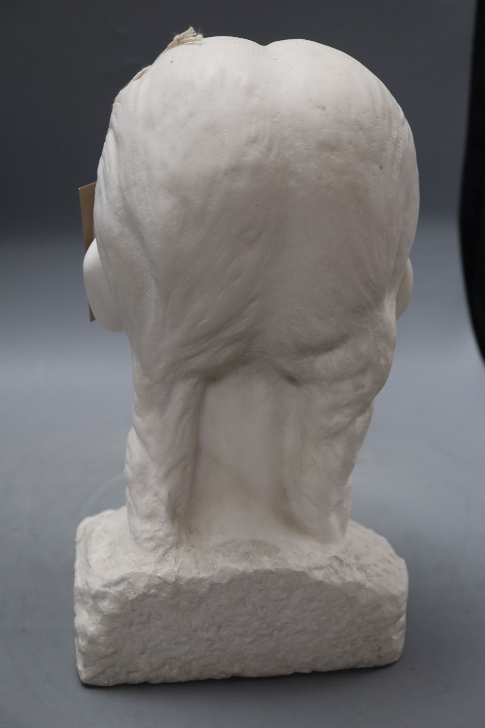 A carved marble head of a girl, signed Lankas 1947, height 29cm
